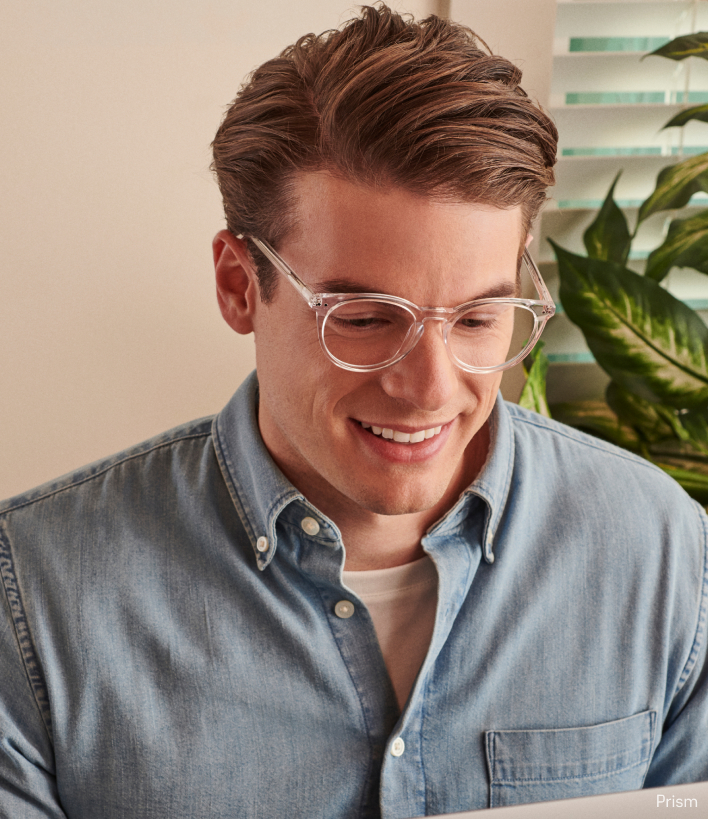A man wearing blue light glasses